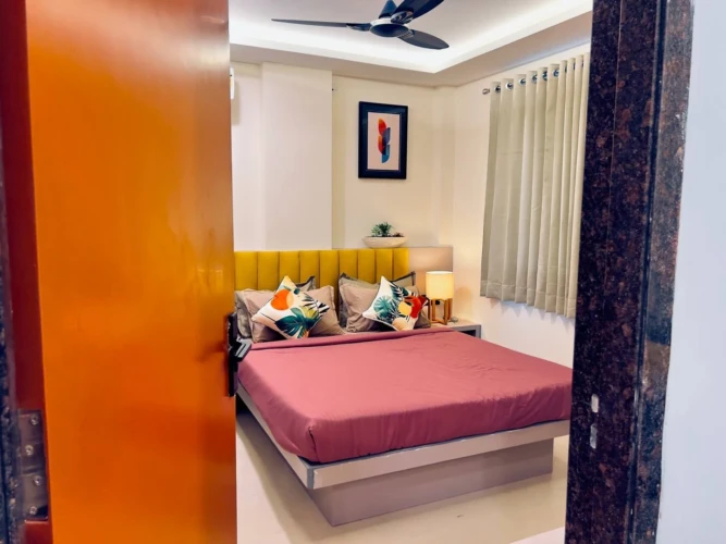 Modern bedroom with double bed and cozy interior in a fully furnished service apartment